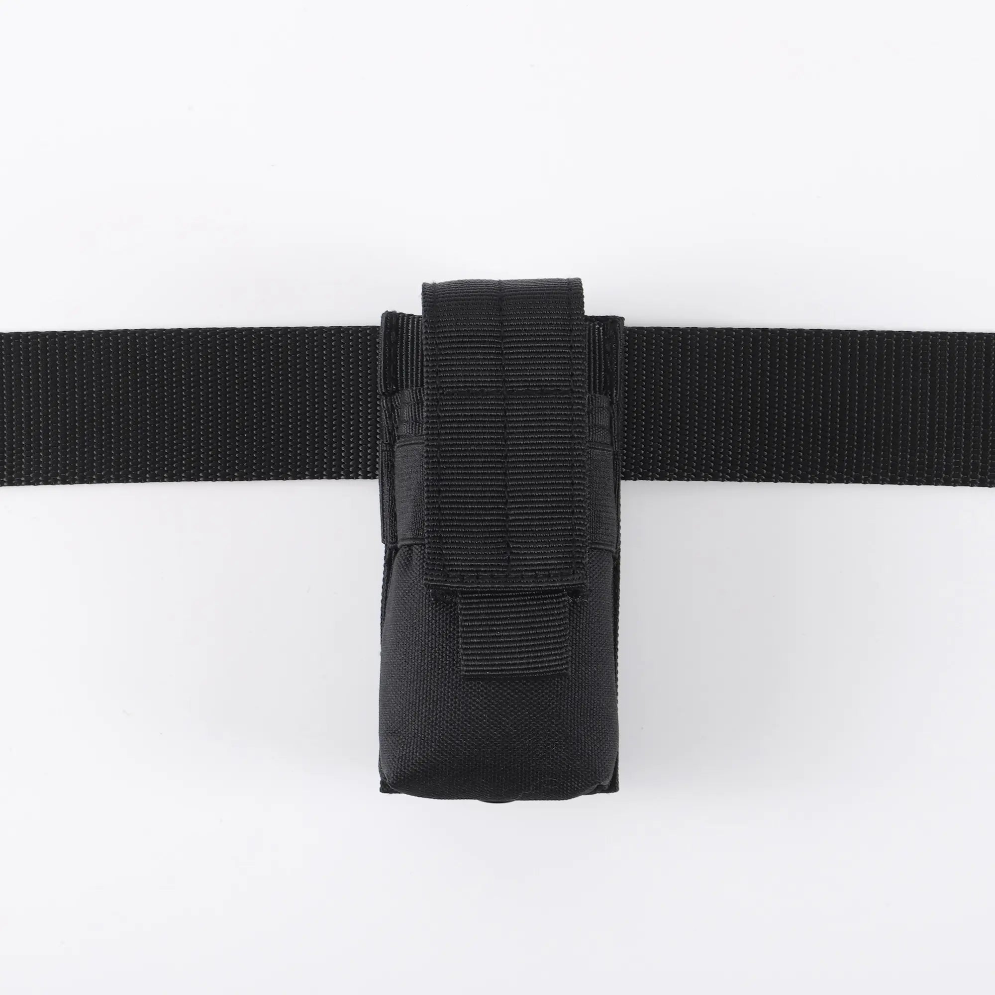 Black flashlight holder viewed on black belt