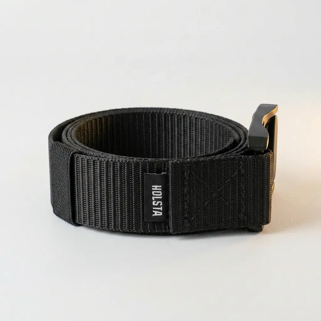 Black belt with a visible brand logo on a light gray background