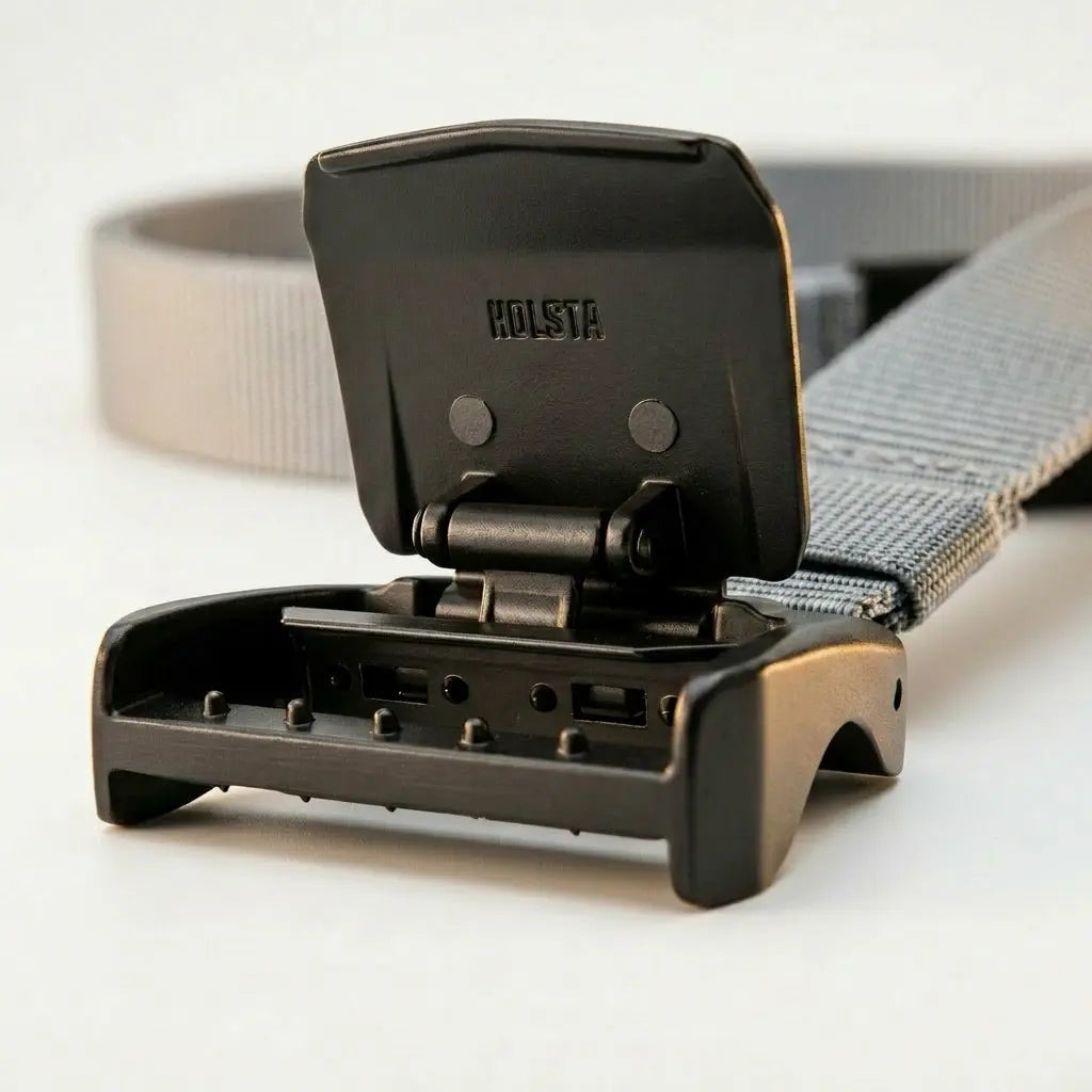 Gray belt with a black buckle on a light gray background