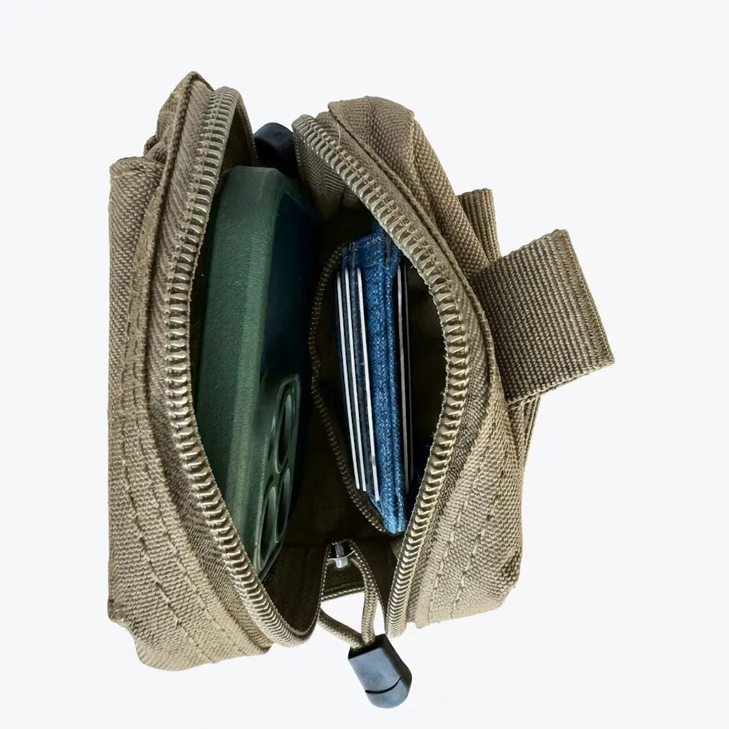 An open tactical phone pouch in olive drab canvas, showing its interior compartments filled with a green phone case and credit cards, on a solid white background.