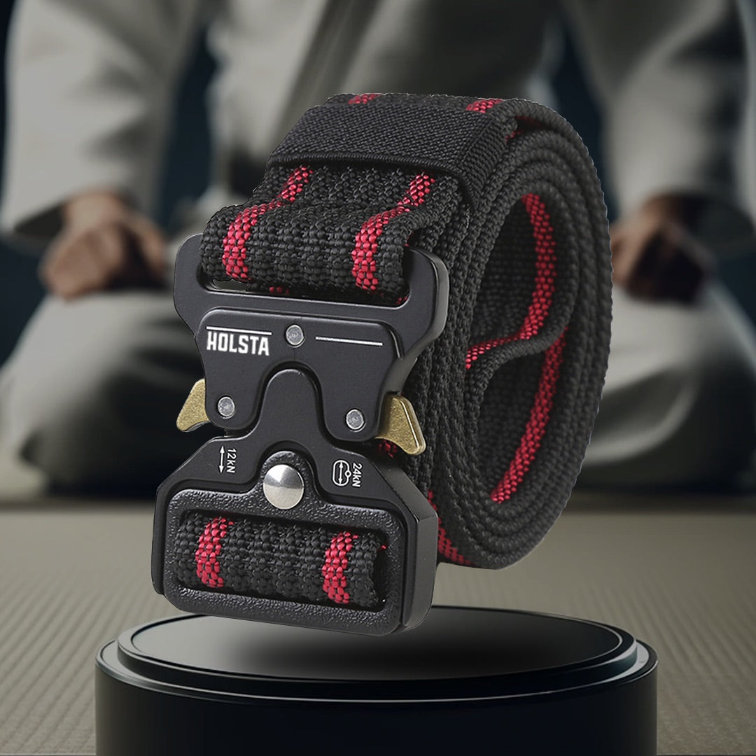 Red and black striped belt on pedestal with judo player behind