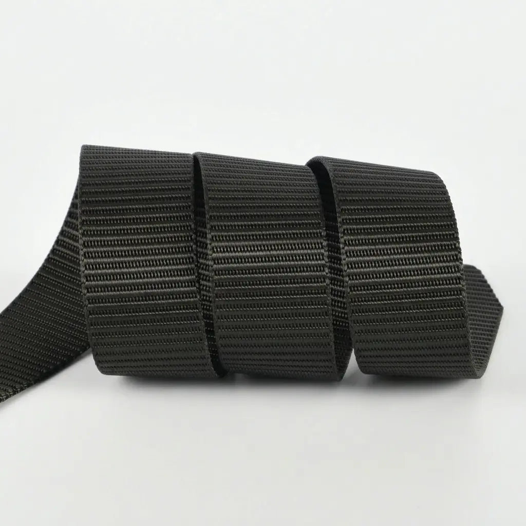Black strap with a textured pattern on a white background