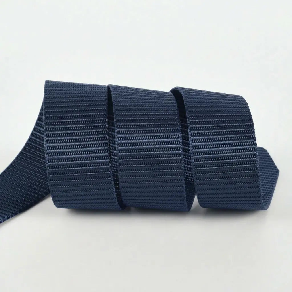 Black webbing with a textured pattern on a white background