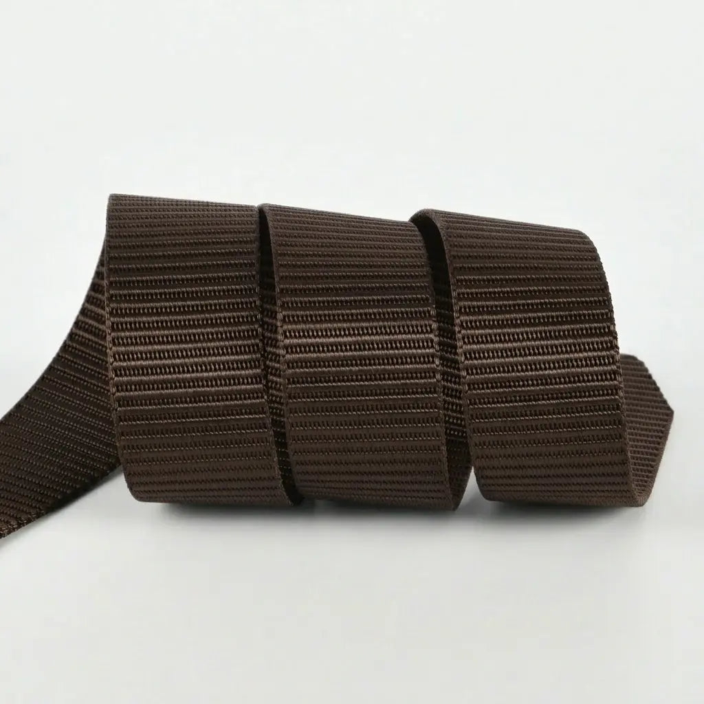 Dark brown belt with a metallic buckle on a light gray background