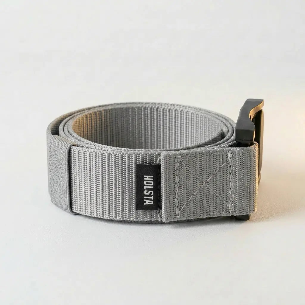 Gray belt with a black buckle on a light gray background